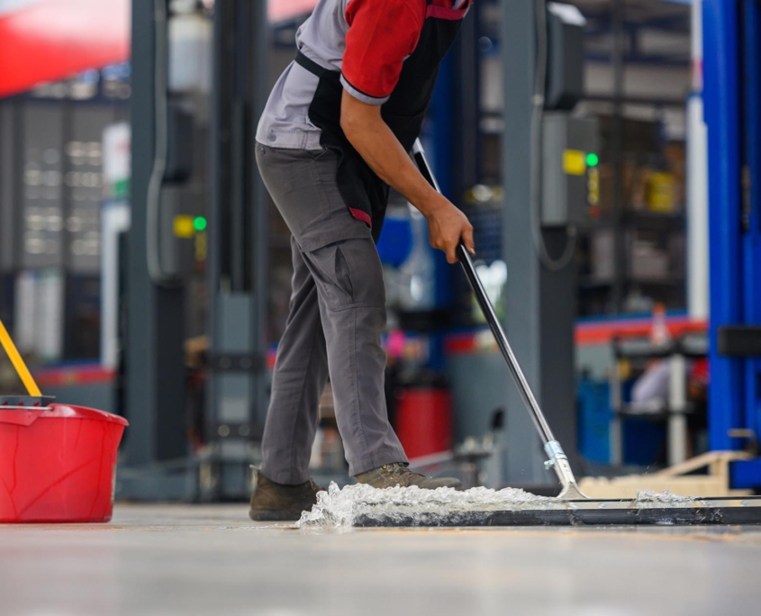 Worker Cleaning Warehouse